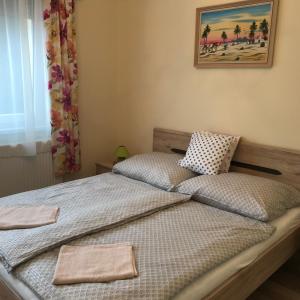 1 dormitorio con 2 camas y toallas. en Mona Home, en Hévíz