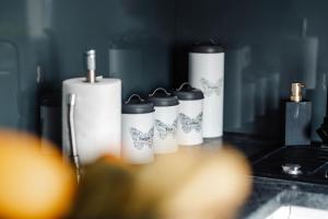 a group of four white cylinders sitting on a counter at Apartament Staszica Nowa Sól in Nowa Sól