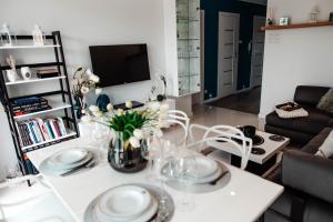 a living room with a white table and chairs at Apartament Staszica Nowa Sól in Nowa Sól