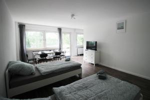a living room with a bed and a dining room table at Cozy Apartment in Remscheid in Radevormwald