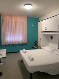 a hospital room with a large bed and a window at Hotel Gioia in San Benedetto del Tronto