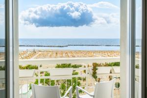 a view of the beach from the balcony of a resort at Hb Hotels Orchidea Blu in Rimini