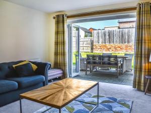 a living room with a couch and a table at Centurion Rise in Penrith