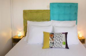a bed with white pillows and a blue headboard at Villa Silentio Luxury with pool, jacuzzi & sauna in Podgora +49 photos