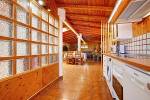 a kitchen and dining room with wooden walls and windows at La Casita de Vidal in Tuineje +23 photos