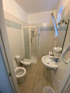 a bathroom with a toilet and a sink and a shower at Hotel Gioia in San Benedetto del Tronto