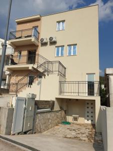 a building with balconies on the side of it at Apartments Bulatovic in Budva