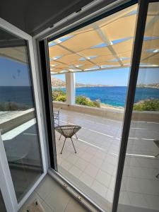 a view of the ocean from the balcony of a house at Villa Mavromichali private beach in Liaropá