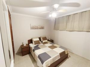 a bedroom with a bed and a ceiling fan at Apartamento Idaira Sun in Los Cristianos
