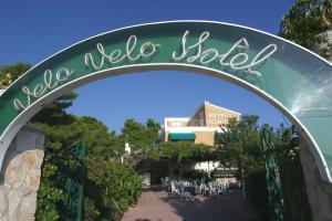 a gate to a patio with tables and chairs at Hotel Vela Velo Club Vieste in Vieste