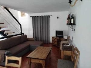 a living room with a couch and a table at Di&Ana II - Alojamento Vila Viçosa in Vila Viçosa