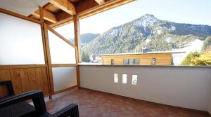 a room with a large window with a mountain view at Apartments Antersi Claudia in San Vigilio Di Marebbe