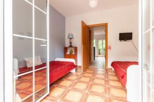 a hotel room with two beds and a television at Sea view maisonette near Nafplio!1' drive to beach in Kivérion