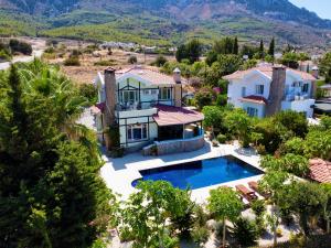 an aerial view of a villa with a swimming pool at 4 Bedroom Deluxe Villa with Mountain and Sea View in Kérynia
