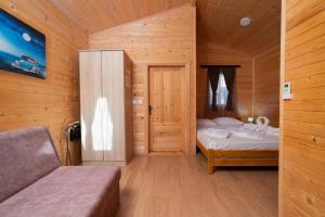 a small bedroom with a bed and a wooden wall at Sunny Garden Pansion in Ulcinj