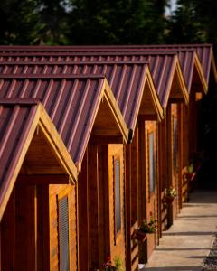 a row of wooden buildings with a roof at Sunny Garden in Ulcinj