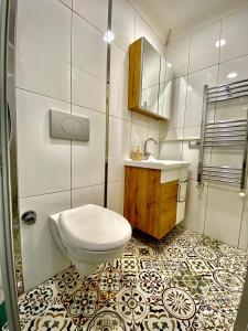 a bathroom with a toilet and a sink at Heaven Meydan Apartments in Trabzon