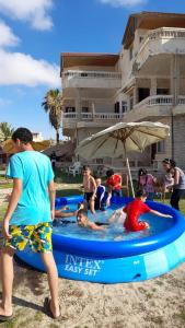a group of people in a pool on the beach at قريه جرين لاند العريش in Arish