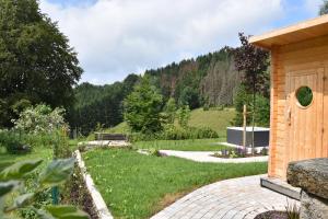 a garden with a stone pathway and a building at Asten-Chalets in Winterberg