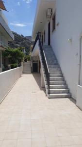 a set of stairs leading to a building with a stair case at Mary Apartments in Stalida