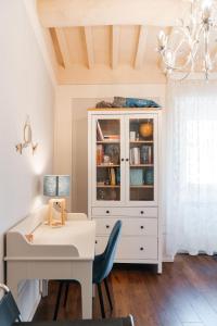 a white desk with a chair next to a white cabinet at Ginevra Suite in Cortona +17 photos