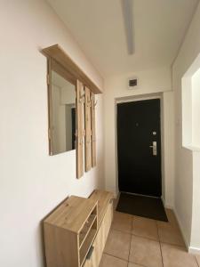 a bathroom with a wooden dresser and a mirror at Apartament centru in Râmnicu Vâlcea