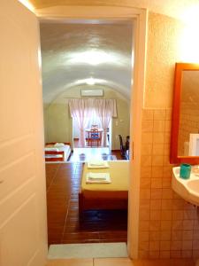 a view of a room with a bed and a bathroom at Loukas Kontos Traditional House in Emporio