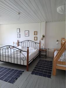 a bedroom with a large bed and a staircase at Kustnära Vandrarhem in Hamburgsund