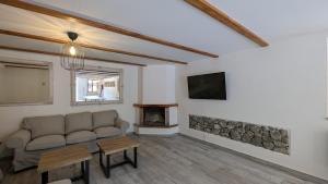 a living room with a couch and a fireplace at Casas El Jogueru in Ribadesella