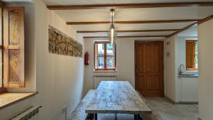 a dining room with a wooden table in a room at Casas El Jogueru in Ribadesella