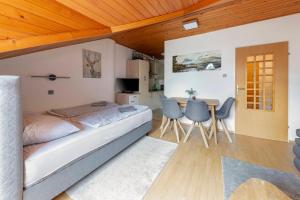 a bedroom with a bed and a table and chairs at Apartma Alpine Space, Kranjska Gora - Center in Kranjska Gora