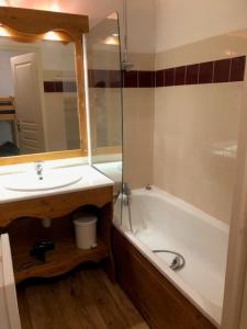 a bathroom with a sink and a tub and a mirror at V du Bachat Arolles A12 - Appt 6 pers in Chamrousse
