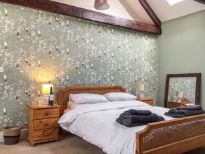 a bedroom with a bed and a green wall at The Croft in Longhorsley
