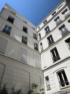 a large white building with a lot of windows at Authentic Parisian 65m2 flat next to Le Marais in Paris