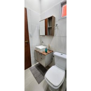 a bathroom with a toilet and a sink at Casa Acerola - Vila de São Jorge in Sao Jorge