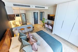 a bedroom with a king sized bed and a kitchen at Stunning 12th floor apartment with private balcony at 16onBree in Cape Town