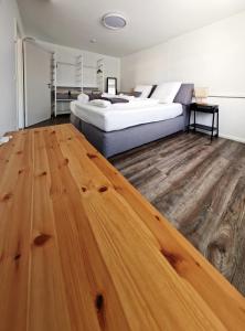 a bedroom with two beds and a wooden floor at Ferienwohnung Wiehl - Bielstein in Wiehl