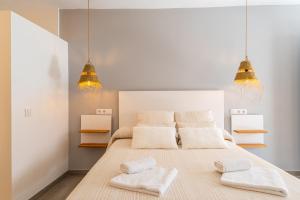 a bedroom with a large bed with two pillows at Calas De Meca in Los Caños de Meca