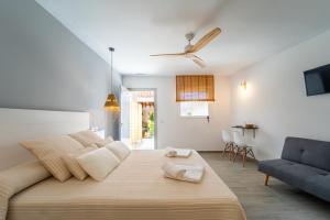 a bedroom with a large bed and a blue chair at Calas De Meca in Los Caños de Meca
