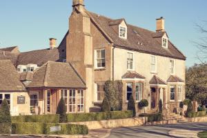 a large brick house with a roof at Dormy House Hotel in Broadway