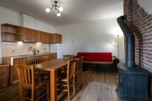 a kitchen with a wooden table and a wood stove at VILA Stella in Bystrá