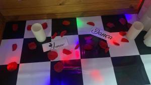 a table with a chessboard with hearts on it at Cabana Amor Perfeito in Alfredo Wagner