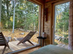 a bedroom with a large window in a wooden cabin at Ennu’s hut in Loksa