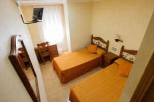 Postel nebo postele na pokoji v ubytování Hotel Beatriz