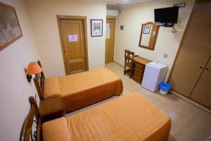 Postel nebo postele na pokoji v ubytování Hotel Beatriz