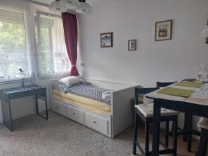 a small room with a bed and a table at Studio bei Nussensee in Bad Ischl