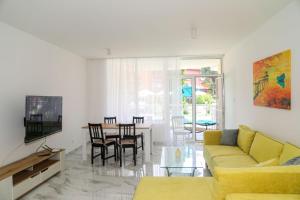 a living room with a couch and a table at Oasis dream apartment with pool by the sea in Nesebar