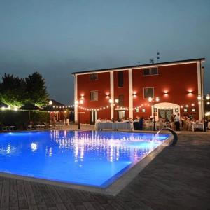 a large blue swimming pool in front of a building at Agriturismo La Caffettiera in Sparanise