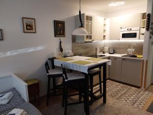 a kitchen with a table and some chairs in it at Studio bei Nussensee in Bad Ischl