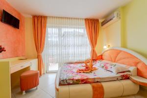 a bedroom with a bed and a window at Boutique Guest House 'Sofia' in Nesebar